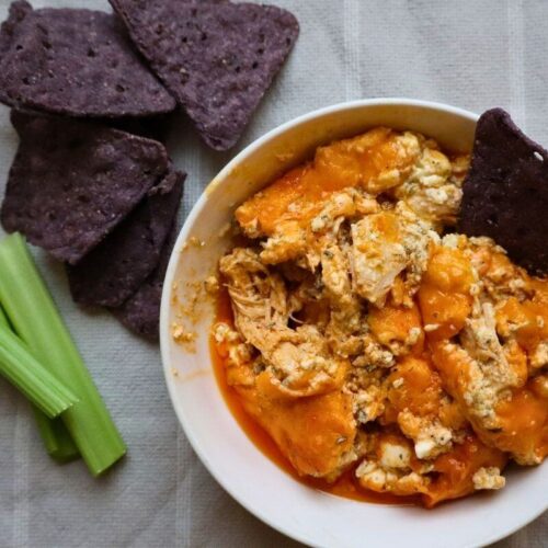 healthy buffalo chicken dip served with chips and veggies