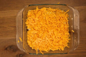 8x8 baking pan with unbaked chicken wing dip