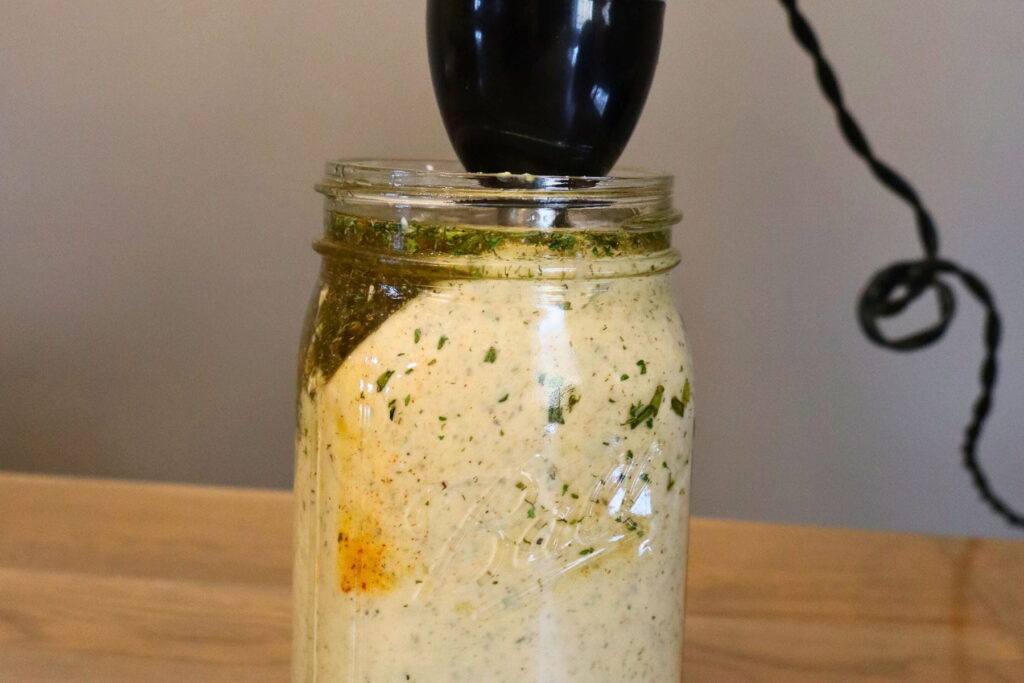 immersion blender mixing ranch dressing in jar