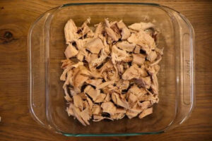 8x8 baking pan with cooked chicken