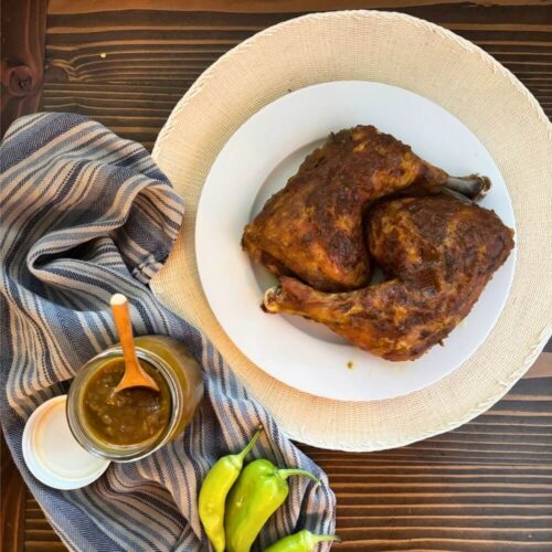 Homemade Gluten-Free Sweet Banana Pepper Honey Mustard Sauce (No Flour Needed) 6 baked chicken covered in banana pepper sauce with a jar full of banana pepper sauce and whole banana peppers on a table