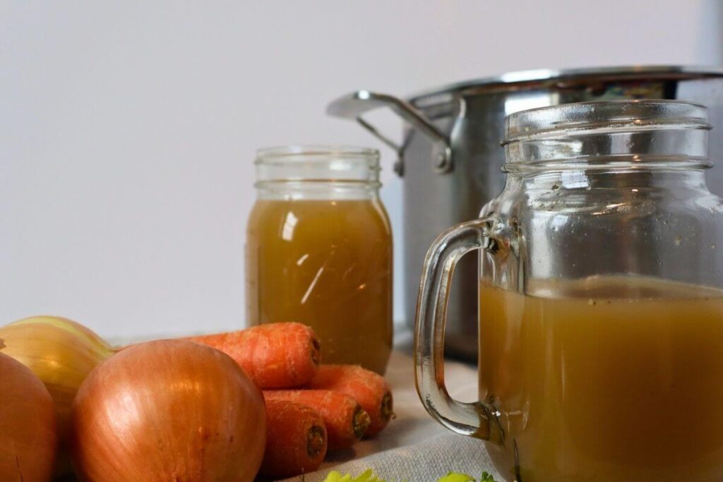 finished beef bone broth with a stockpot