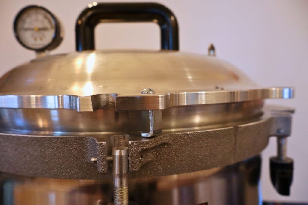 Pressure canner with the lid cracked allowing the temperature to equalize.