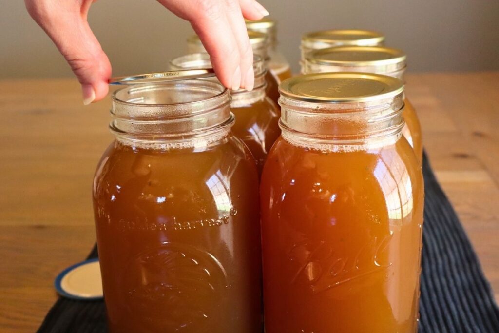 Placing lids on mason jars, getting them ready to pressure can.