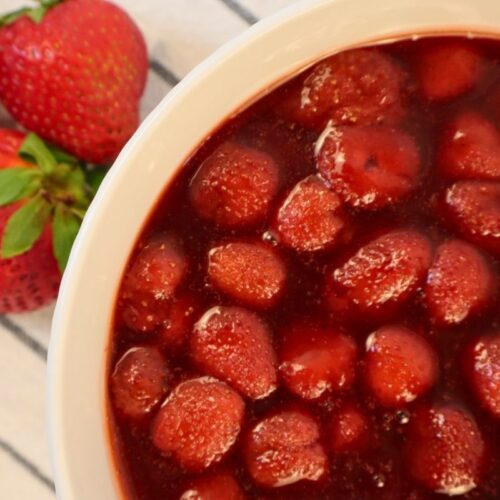 From-scratch strawberry sauce made with frozen strawberries in a bowl.