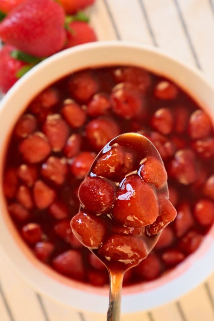 Thickened strawberry sauce texture shown up close — simple, delicious sauce for pancakes, cheesecake, and more.