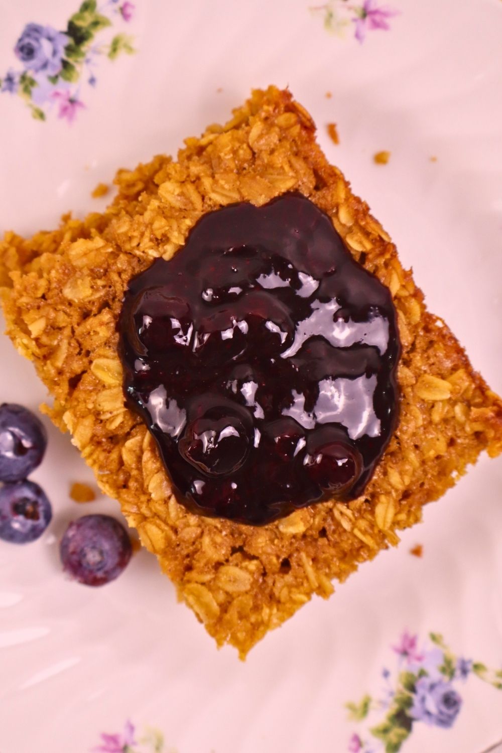 Warm baked oatmeal topped with homemade blueberry sauce and fresh blueberries — easy berry sauce recipe for a wholesome breakfast