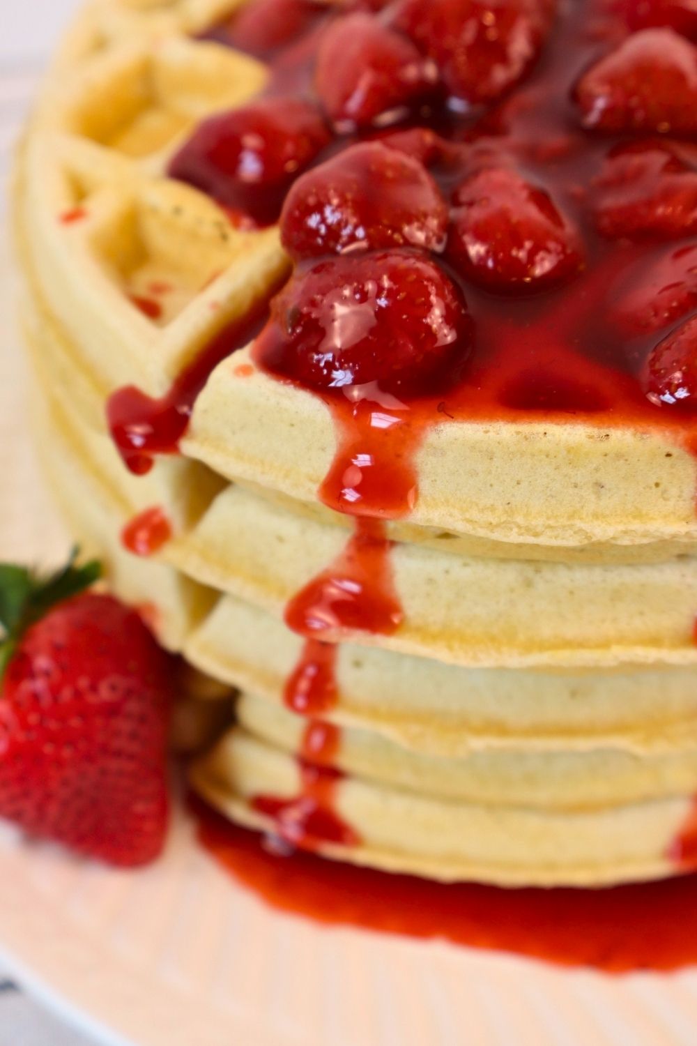 Thick homemade chunky strawberry sauce poured over crispy waffles — easy berry sauce recipe for a wholesome breakfast treat