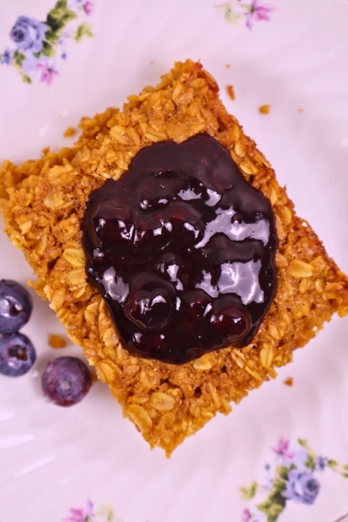 Baked oatmeal topped with homemade blueberry sauce made from frozen blueberries — easy breakfast idea.