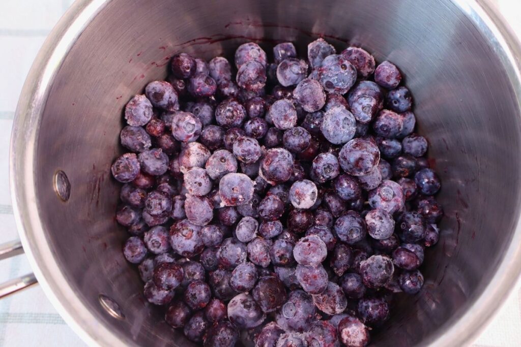 Frozen blueberries in a kettle ready to be heated.