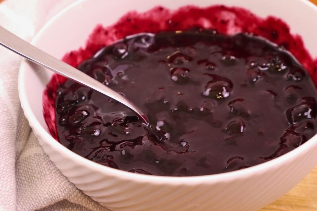 A bowl of homemade blueberry sauce ready to serve.