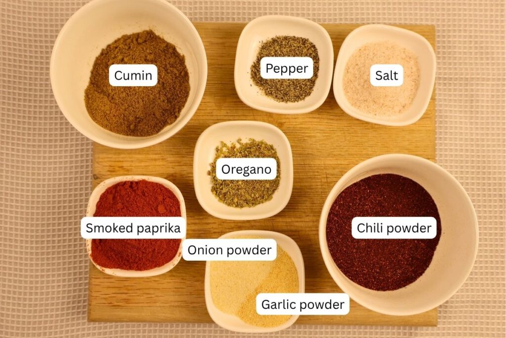 Individual ingredients for homemade taco seasoning recipe in small bowls.