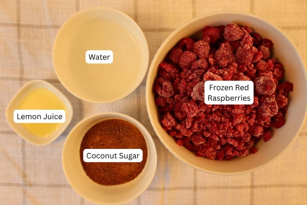 How to Make Raspberry Sauce with Frozen Raspberries 5 Ingredients for raspberry sauce arranged in individual bowls, showing everything needed for how to make raspberry sauce.