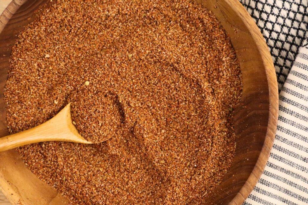 Overhead view of a bowl of taco seasoning with a spoon inside