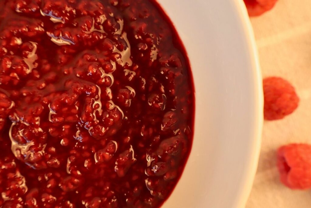How to Make Raspberry Sauce with Frozen Raspberries 10 Overhead shot of raspberry sauce in a bowl.