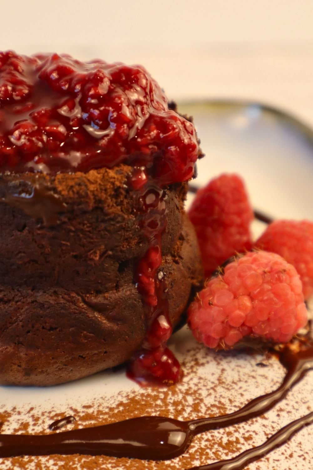 How to Make Raspberry Sauce with Frozen Raspberries 3 Warm chocolate lava cake topped with bright raspberry sauce — rich, decadent dessert idea with fresh berry flavor.