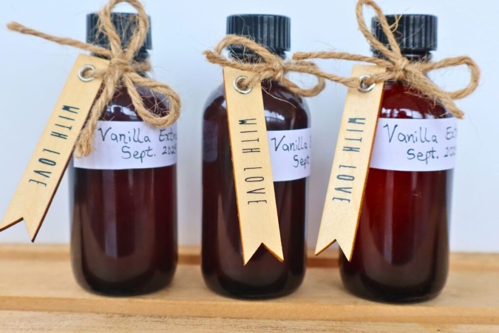 Large Batch Homemade Vanilla Extract Recipe with Vodka 15 Three small bottles of homemade vanilla extract labeled and ready for gifting