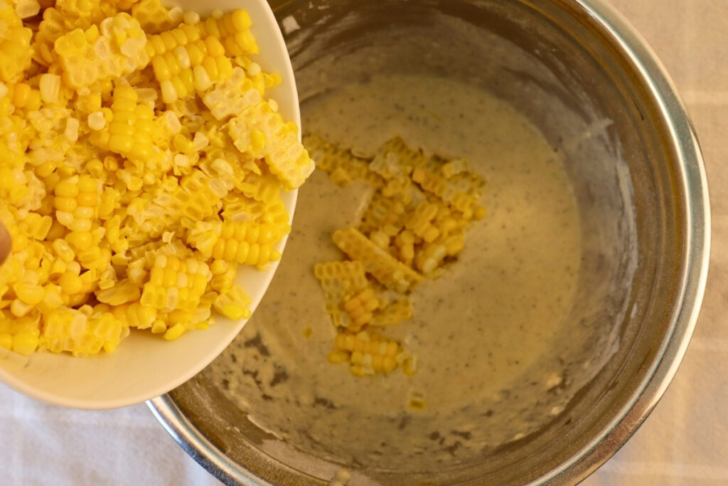 Gluten-Free Pennsylvania Dutch Corn Fritters 10 Fresh corn kernels being added to gluten-free corn fritter batter