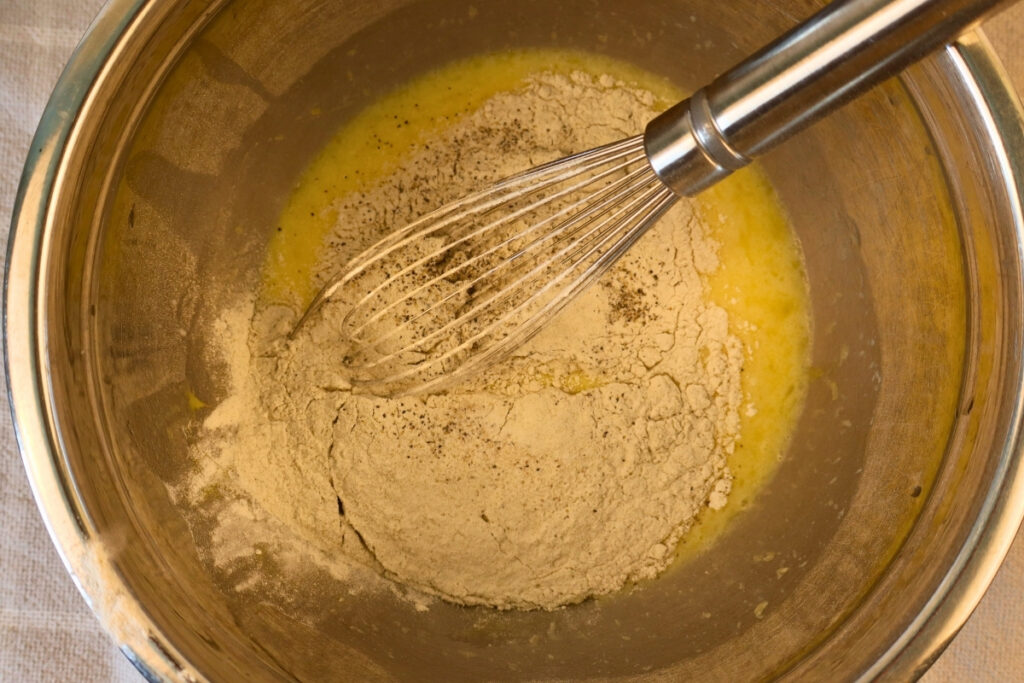 Gluten-Free Pennsylvania Dutch Corn Fritters 9 Buckwheat flour mixture being whisked into the wet ingredients for corn fritter batter