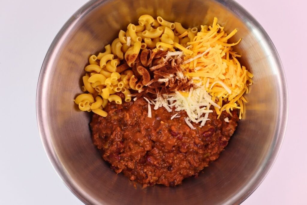 Easy Baked Gluten-Free Chili Mac 5 Macaroni, chili, and shredded cheese layered in a bowl before mixing for gluten-free chili mac