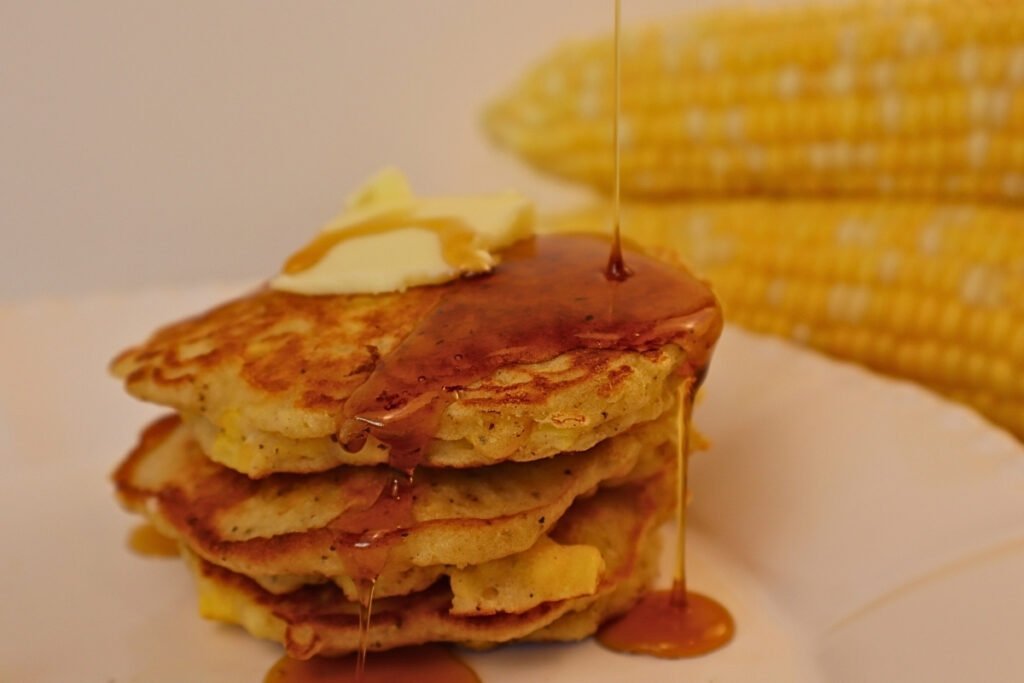 Gluten-Free Pennsylvania Dutch Corn Fritters 17 Stack of gluten-free Pennsylvania Dutch corn fritters topped with butter and maple syrup