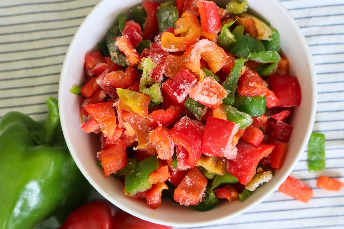 Bowl of frozen diced sweet peppers with visible frost