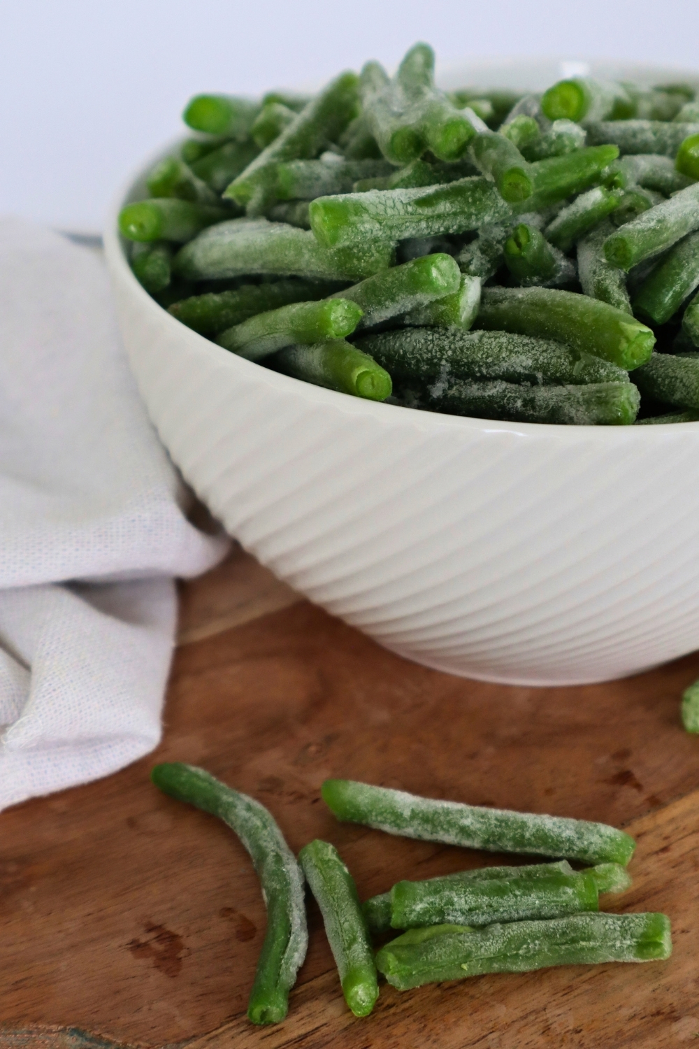 How to Freeze Fresh Green Beans From the Garden 13 Frozen green beans in a white bowl: learn how to freeze fresh green beans so they stay bright green and ready to use all winter